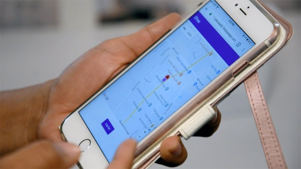 hands holding an iPhone displaying current location on map